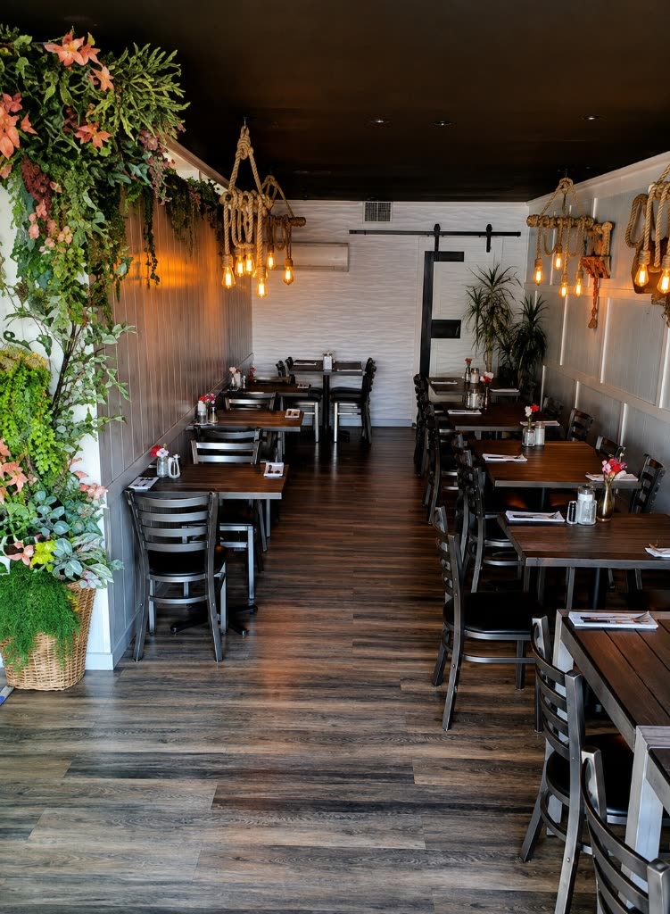 Estime's Cafe Beautiful Dining Room Interior with Botanical Wall and Rustic Lighting in Colonia NJ
